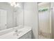 Bright bathroom featuring large mirror, white vanity, and shower with bathtub at 1010 Capella Creek Way, Grayson, GA 30017