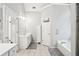Bright bathroom with double sinks, lots of counterspace, bathtub, and a glass shower at 1010 Capella Creek Way, Grayson, GA 30017