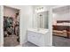 Bright bathroom vanity next to walk-in closet and doorway leading into bedroom at 1010 Capella Creek Way, Grayson, GA 30017