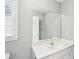 Bright bathroom features a white vanity, large mirror, and ample cabinet space for storage at 1010 Capella Creek Way, Grayson, GA 30017