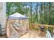 Wooden deck featuring a screened gazebo for outdoor relaxation, overlooking a verdant backyard at 1010 Capella Creek Way, Grayson, GA 30017