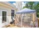 Covered deck with comfortable seating and outdoor table; ideal for outdoor gatherings at 1010 Capella Creek Way, Grayson, GA 30017