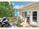 Relaxing deck space featuring patio furniture, grill, and a sunny outdoor atmosphere at 1010 Capella Creek Way, Grayson, GA 30017