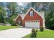 Charming brick home with well-maintained lawn and two car garage with long driveway at 1010 Capella Creek Way, Grayson, GA 30017