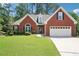 Charming brick home with well-maintained lawn and manicured shrubbery with two car garage at 1010 Capella Creek Way, Grayson, GA 30017