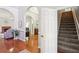 Hallway featuring hardwood floors, gray paint, and access to the staircase at 1010 Capella Creek Way, Grayson, GA 30017