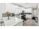Bright kitchen featuring white cabinets, gray backsplash, stainless appliances, and marble countertops at 1010 Capella Creek Way, Grayson, GA 30017