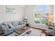 Bright living room with large windows, hardwood floors, and comfortable seating at 1010 Capella Creek Way, Grayson, GA 30017