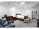 Spacious bedroom featuring tray ceilings, recessed lighting, and cozy seating area at 1010 Capella Creek Way, Grayson, GA 30017