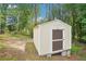 Exterior of a storage shed on a concrete foundation, set among trees with easy access for storing tools at 1010 Capella Creek Way, Grayson, GA 30017