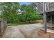Spacious backyard featuring a concrete patio, lush greenery, a privacy fence, and a hammock for outdoor relaxation at 1634 Glenwood Se Ave, Atlanta, GA 30316