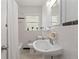 Classic bathroom with white tile, a pedestal sink, and vintage black and white tiled flooring at 1634 Glenwood Se Ave, Atlanta, GA 30316