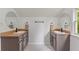 A modern bathroom features two vanities with large round mirrors and a window at 1634 Glenwood Se Ave, Atlanta, GA 30316