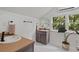 Modern bathroom with neutral colors, a large mirror, and a window with outside view at 1634 Glenwood Se Ave, Atlanta, GA 30316