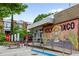Modern restaurant exterior featuring outdoor seating area and colorful mural, set against a backdrop of contemporary townhomes at 1634 Glenwood Se Ave, Atlanta, GA 30316