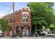Charming brick building with a black awning and vintage architectural details, complemented by lush greenery and street views at 1634 Glenwood Se Ave, Atlanta, GA 30316