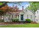 Charming home with a manicured lawn, inviting front porch, and a lush, colorful tree in the front yard at 1634 Glenwood Se Ave, Atlanta, GA 30316