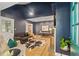 Stylish living room with dark blue walls, a fireplace, and hardwood floors, creating a sophisticated ambiance at 1634 Glenwood Se Ave, Atlanta, GA 30316