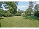 The home's expansive backyard is surrounded by mature trees for privacy and a relaxing outdoor living at 1712 Shirley Sw St, Atlanta, GA 30310