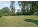 Expansive backyard with mature trees and lush greenery, offering plenty of space for outdoor activities at 1712 Shirley Sw St, Atlanta, GA 30310