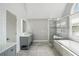 Bright bathroom with a gray double vanity, quartz countertops, and a glass shower at 1712 Shirley Sw St, Atlanta, GA 30310