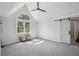 Bright and spacious bedroom with a large arched window and sliding barn door at 1712 Shirley Sw St, Atlanta, GA 30310