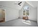 Bright bedroom with large window, ceiling fan, and neutral carpet for a serene atmosphere at 1712 Shirley Sw St, Atlanta, GA 30310