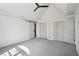 Spacious bedroom with neutral carpet, bi-fold closet doors, and modern barn door at 1712 Shirley Sw St, Atlanta, GA 30310