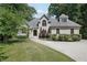 Charming home with well-manicured lawn, circular driveway, and inviting front entrance framed by mature trees at 1712 Shirley Sw St, Atlanta, GA 30310