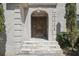 Close-up of the stone staircase and arched doorway leading to the front entrance with the house number at 1712 Shirley Sw St, Atlanta, GA 30310