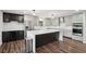 Open kitchen featuring an island, stainless steel appliances, and hardwood flooring at 1712 Shirley Sw St, Atlanta, GA 30310