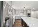 Modern kitchen with an island, stainless steel refrigerator, and white backsplash at 1712 Shirley Sw St, Atlanta, GA 30310
