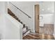Elegant staircase with wood treads, white risers, and a modern railing at 1712 Shirley Sw St, Atlanta, GA 30310