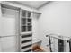 Walk-in closet with custom shelving and hardwood flooring at 1712 Shirley Sw St, Atlanta, GA 30310