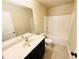 Bathroom featuring a shower and tub combination with dark cabinets at 2378 Misty Ivy Ct, Buford, GA 30519