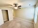 Neutral bedroom with carpet flooring, a ceiling fan, and a walk-in closet at 2378 Misty Ivy Ct, Buford, GA 30519