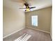 Neutral bedroom featuring carpeted flooring, a ceiling fan, and a window at 2378 Misty Ivy Ct, Buford, GA 30519