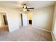 Neutral bedroom featuring carpeted flooring, multiple doors and a ceiling fan at 2378 Misty Ivy Ct, Buford, GA 30519