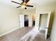 Well-lit bedroom featuring carpeted floor, a ceiling fan, closet and an ensuite bathroom at 2378 Misty Ivy Ct, Buford, GA 30519