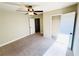 Bright bedroom with a ceiling fan, carpeted floor, closet and ensuite door at 2378 Misty Ivy Ct, Buford, GA 30519