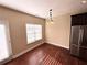 Bright dining area featuring hardwood floors, natural light from large windows, and modern pendant lighting at 2378 Misty Ivy Ct, Buford, GA 30519