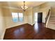 Elegant dining room with hardwood floors, wainscoting detail, and a view of the home's entry at 2378 Misty Ivy Ct, Buford, GA 30519