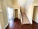 Foyer features hardwood floors, a carpeted staircase, and an open view of the home's interior at 2378 Misty Ivy Ct, Buford, GA 30519