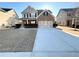 A well-manicured lawn enhances this home's exterior, featuring a two-car garage and brick facade at 2378 Misty Ivy Ct, Buford, GA 30519