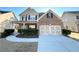 Two-story brick front home featuring a two car garage and well manicured landscaping at 2378 Misty Ivy Ct, Buford, GA 30519