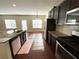 Open kitchen with stainless steel appliances, granite countertops, and an eat-in area with natural light at 2378 Misty Ivy Ct, Buford, GA 30519