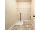 Functional laundry room with tile flooring and utility connections at 2378 Misty Ivy Ct, Buford, GA 30519