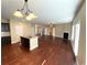 Open floor plan with hardwood floors, a fireplace, and a kitchen island with granite countertops at 2378 Misty Ivy Ct, Buford, GA 30519