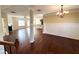 Open-concept living space with hardwood floors, fireplace, and direct access to the kitchen area at 2378 Misty Ivy Ct, Buford, GA 30519
