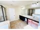Bright main bathroom with dual sinks, soaking tub, and a glass-enclosed shower at 2378 Misty Ivy Ct, Buford, GA 30519